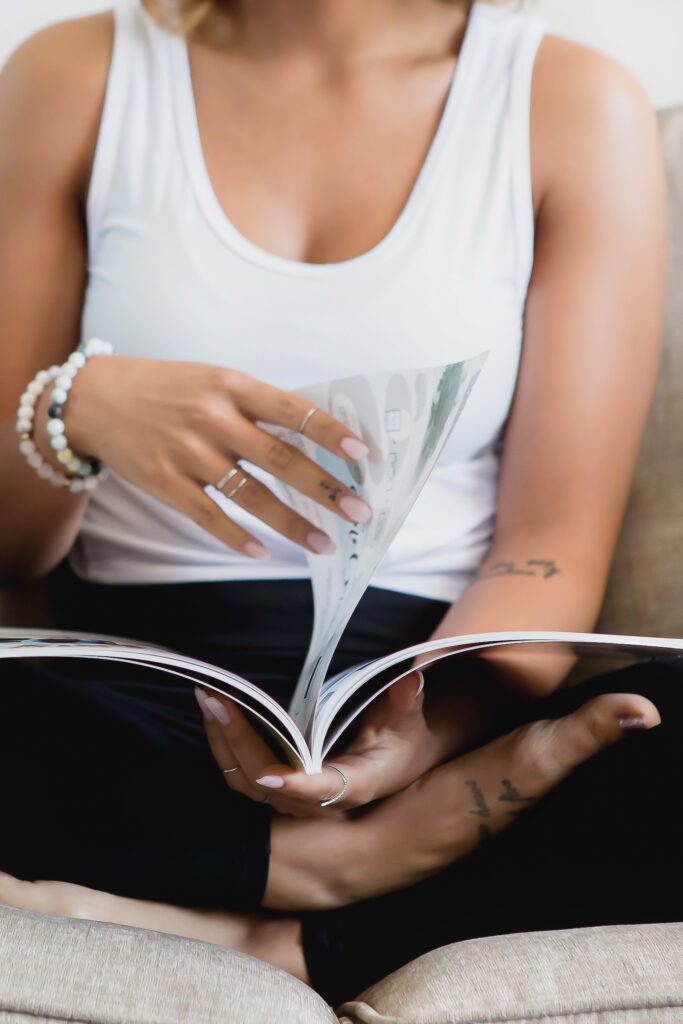 midlife minimalist tattoo on woman reading magazine