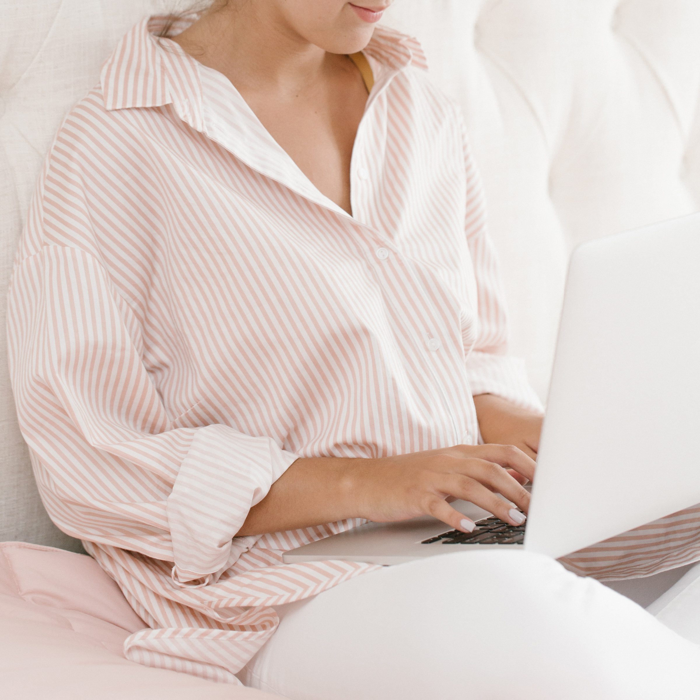 midlife woman in striped shirt working from home