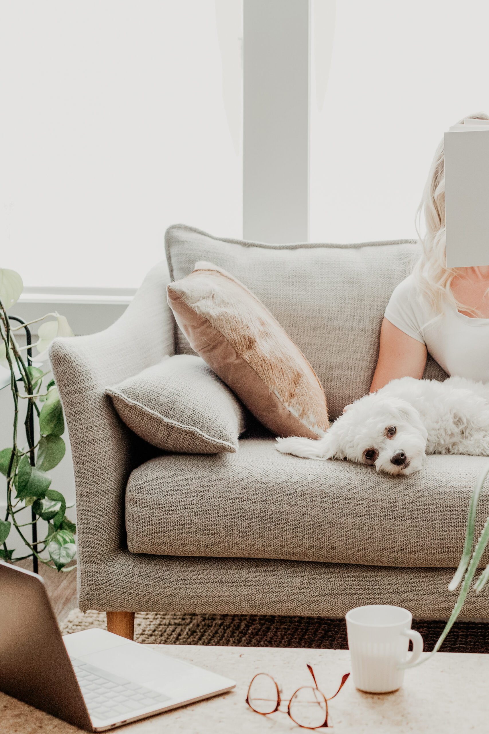 woman resting with dog on couch